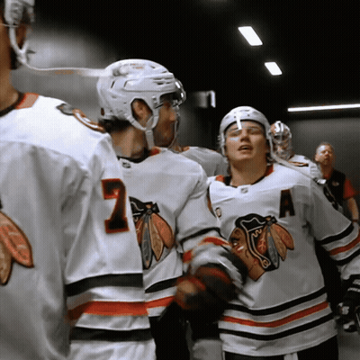 A Hockey Player Wearing A Number 7 Jersey Talks To Another Player GIF