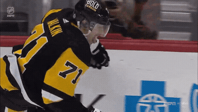 A Hockey Player Wearing A Number 71 Jersey GIF