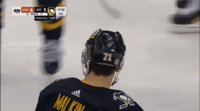 A Hockey Player Wearing A Number 71 Jersey GIF