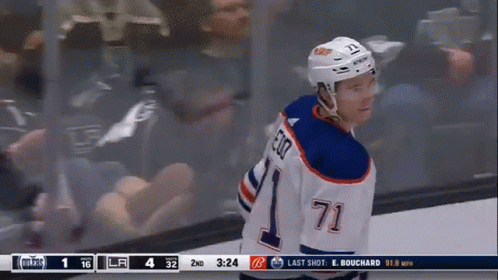 A Hockey Player Wearing A Number 71 Jersey Stands On The Ice GIF