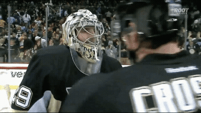 A Hockey Player Wearing A Number 9 Jersey Talks To Another Player GIF