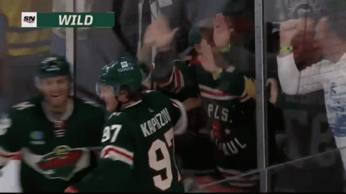 A Hockey Player Wearing A Number 97 Jersey Is Surrounded By Fans GIF