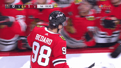 A Hockey Player Wearing A Number 98 Jersey GIF