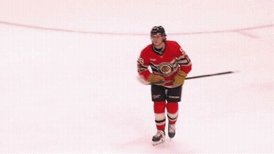 A Hockey Player Wearing A Red Black And White Jersey That Says Blackhawks On It GIF
