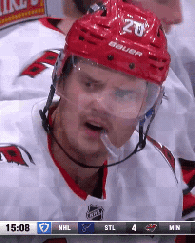 A Hockey Player Wearing A Red Helmet With The Number 20 GIF