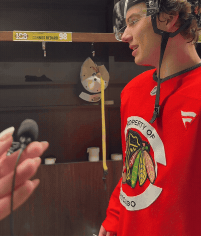 A Hockey Player Wearing A Red Jersey That Says " Property Of Chicago " GIF