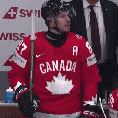 A Hockey Player Wearing A Red Jersey With Canada On It GIF