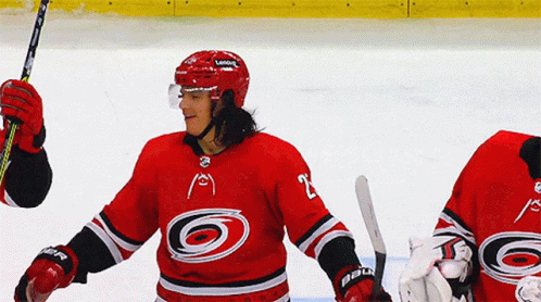 A Hockey Player Wearing A Red Jersey With The Number 2 On It GIF