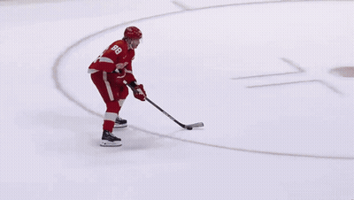 A Hockey Player Wearing A Red Jersey With The Number 8 On It GIF