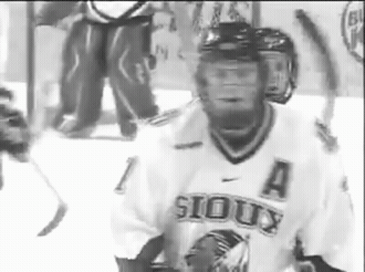 A Hockey Player Wearing A Sioux Jersey Is On The Ice GIF