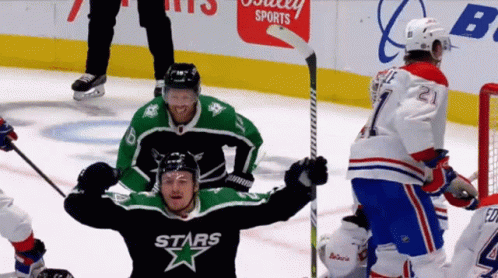 A Hockey Player Wearing A Stars Jersey Holds His Arms In The Air GIF