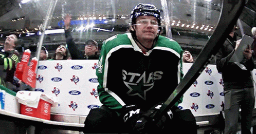 A Hockey Player Wearing A Stars Jersey Holds His Stick GIF