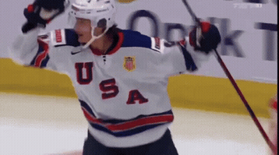 A Hockey Player Wearing A Usa Jersey Is Holding A Stick GIF