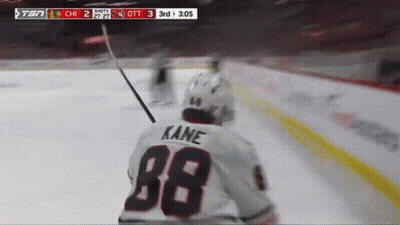 A Hockey Player Wearing A White Jersey With Kane On The Back GIF