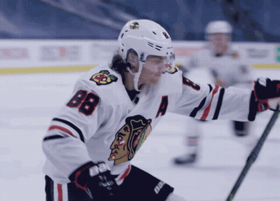 A Hockey Player Wearing A White Jersey With The Number 88 On It GIF