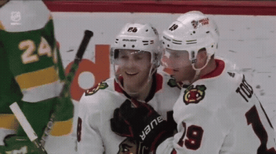 A Hockey Player Wearing A White Jersey With The Number 9 On It GIF