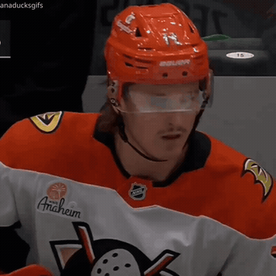 A Hockey Player Wearing An Anaheim Jersey And A Red Helmet GIF