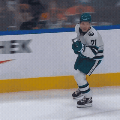 A Hockey Player Wearing Number 71 Is Holding A Hockey Stick GIF