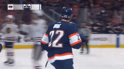 A Hockey Player Wearing The Number 12 Jersey GIF