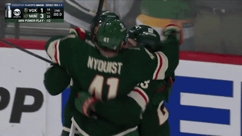 A Hockey Player With Nyquist On His Jersey Hugging His Teammates GIF