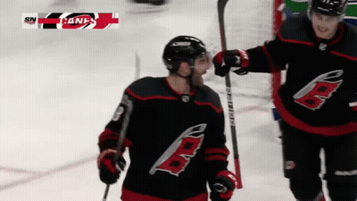 A Hockey Player With The Letter B On His Jersey Is Holding A Hockey Stick GIF