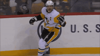 A Hockey Player With The Letter C On His Jersey Is Holding A Stick GIF