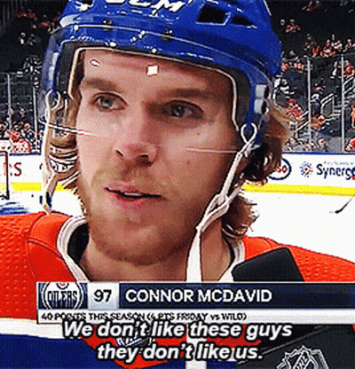A Hockey Player With The Name Connor Mcdavid On The Bottom Of The Screen GIF