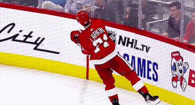 A Hockey Player With The Name Larkin On His Back GIF