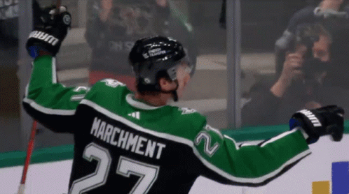 A Hockey Player With The Name Marchment On The Back Of His Shirt GIF