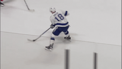 A Hockey Player With The Name Rice On His Jersey Is Holding A Hockey Stick GIF
