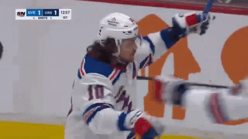 A Hockey Player With The Number 10 On His Jersey Celebrates GIF