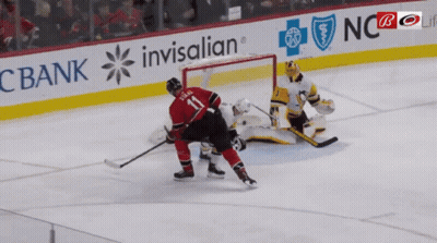 A Hockey Player With The Number 11 On His Back GIF