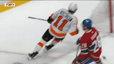 A Hockey Player With The Number 11 On His Jersey Is Being Chased By Another Player GIF