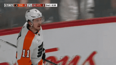 A Hockey Player With The Number 11 On His Jersey Is On The Ice GIF