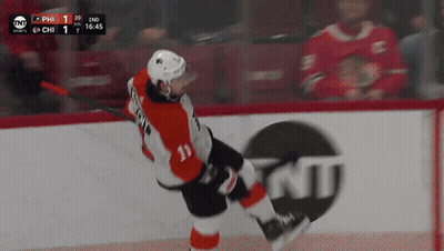 A Hockey Player With The Number 11 On His Jersey Is Skating On The Ice GIF