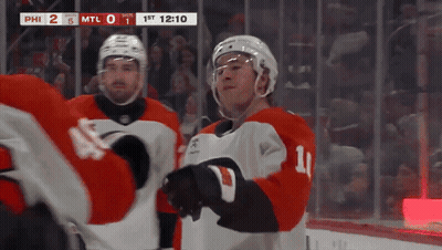 A Hockey Player With The Number 11 On His Jersey Stands On The Ice GIF