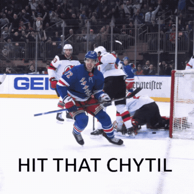 A Hockey Player With The Number 12 On His Jersey Is Skating On The Ice GIF