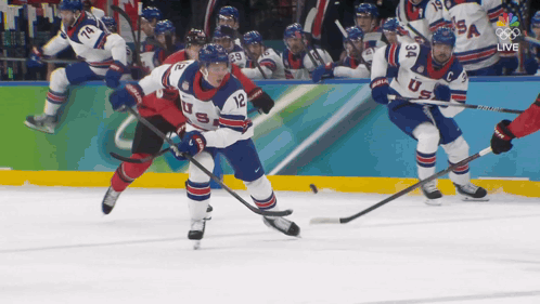 A Hockey Player With The Number 12 On His Jersey Skates On The Ice GIF