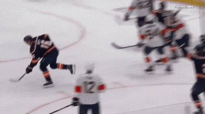 A Hockey Player With The Number 12 On The Back Of His Shirt GIF