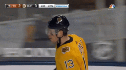 A Hockey Player With The Number 13 On His Jersey Stands On The Ice GIF