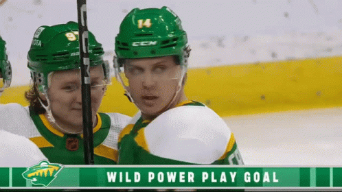 A Hockey Player With The Number 14 On His Helmet Stands Next To Another Player GIF