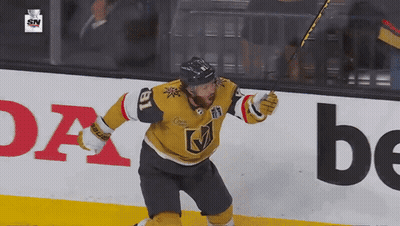 A Hockey Player With The Number 18 On His Jersey Celebrates His Goal GIF
