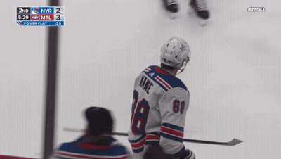 A Hockey Player With The Number 18 On His Jersey Stands On The Ice GIF