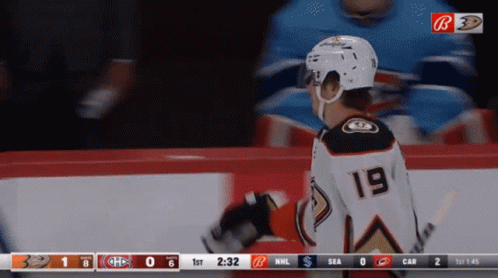 A Hockey Player With The Number 19 On His Back GIF