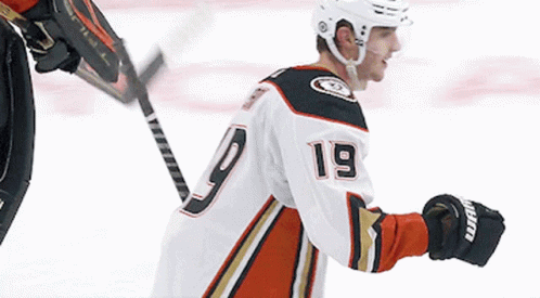 A Hockey Player With The Number 19 On His Jersey Stands On The Ice GIF