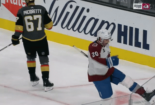 A Hockey Player With The Number 20 On His Jersey Falls On The Ice GIF