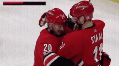 A Hockey Player With The Number 20 On His Jersey Is Hugging Another Hockey Player With The Number 11 On His Jersey GIF