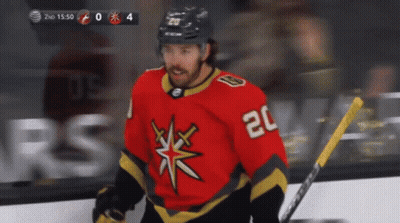 A Hockey Player With The Number 20 On His Jersey Stands On The Ice GIF