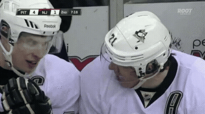 A Hockey Player With The Number 21 On His Helmet Talks To Another Hockey Player GIF