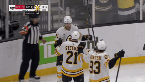 A Hockey Player With The Number 21 On His Jersey Celebrates With His Teammates GIF